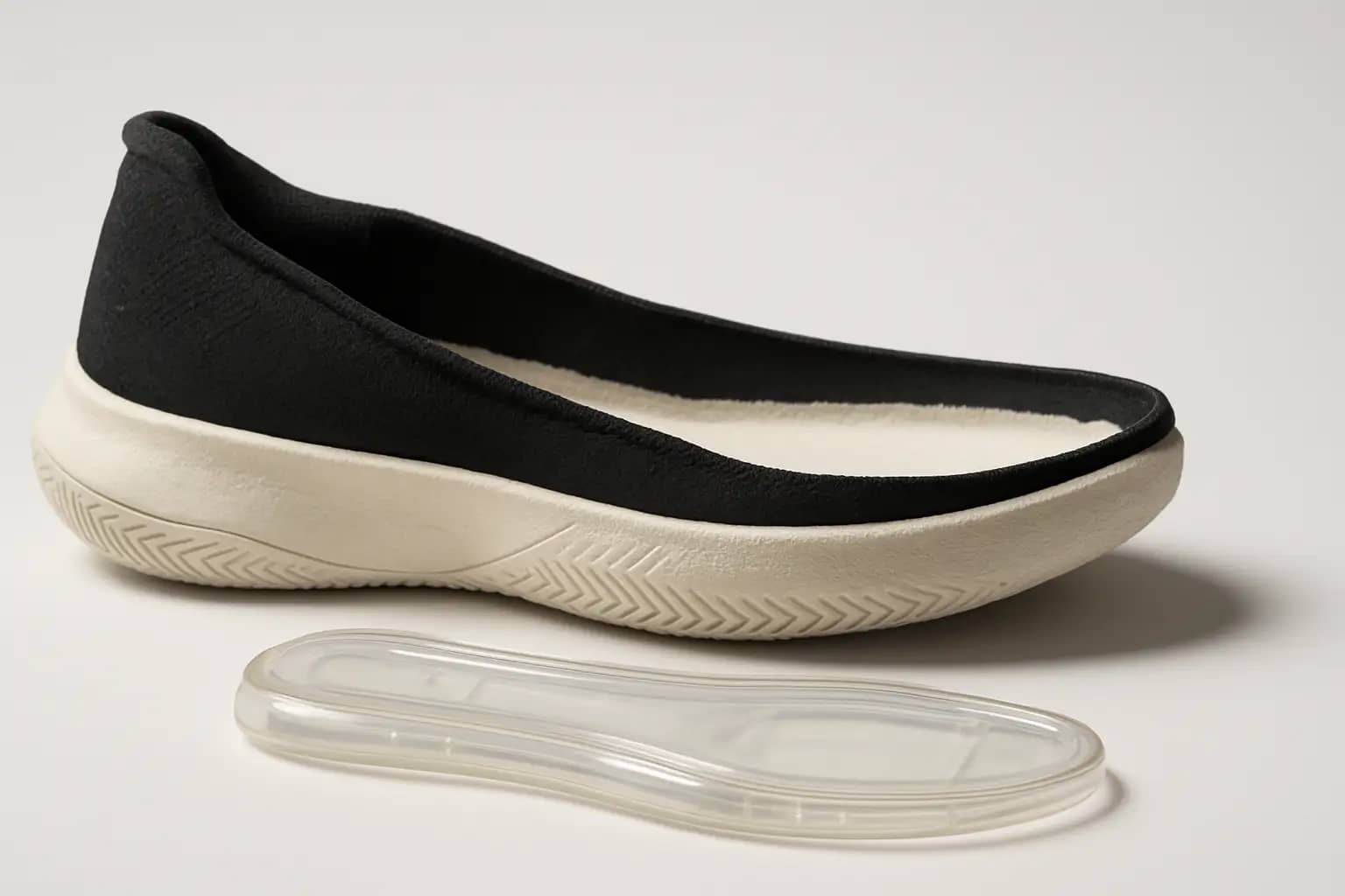 Disassembled basketball shoe showing a Zoom cushioning midsole insert on a clean surface